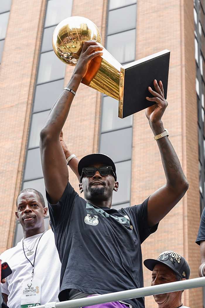 Milwaukee Bucks center Bobby Portis (9) holds the Larry O'Brien NBA Championship Trophy during the Milwaukee Bucks victory parade.